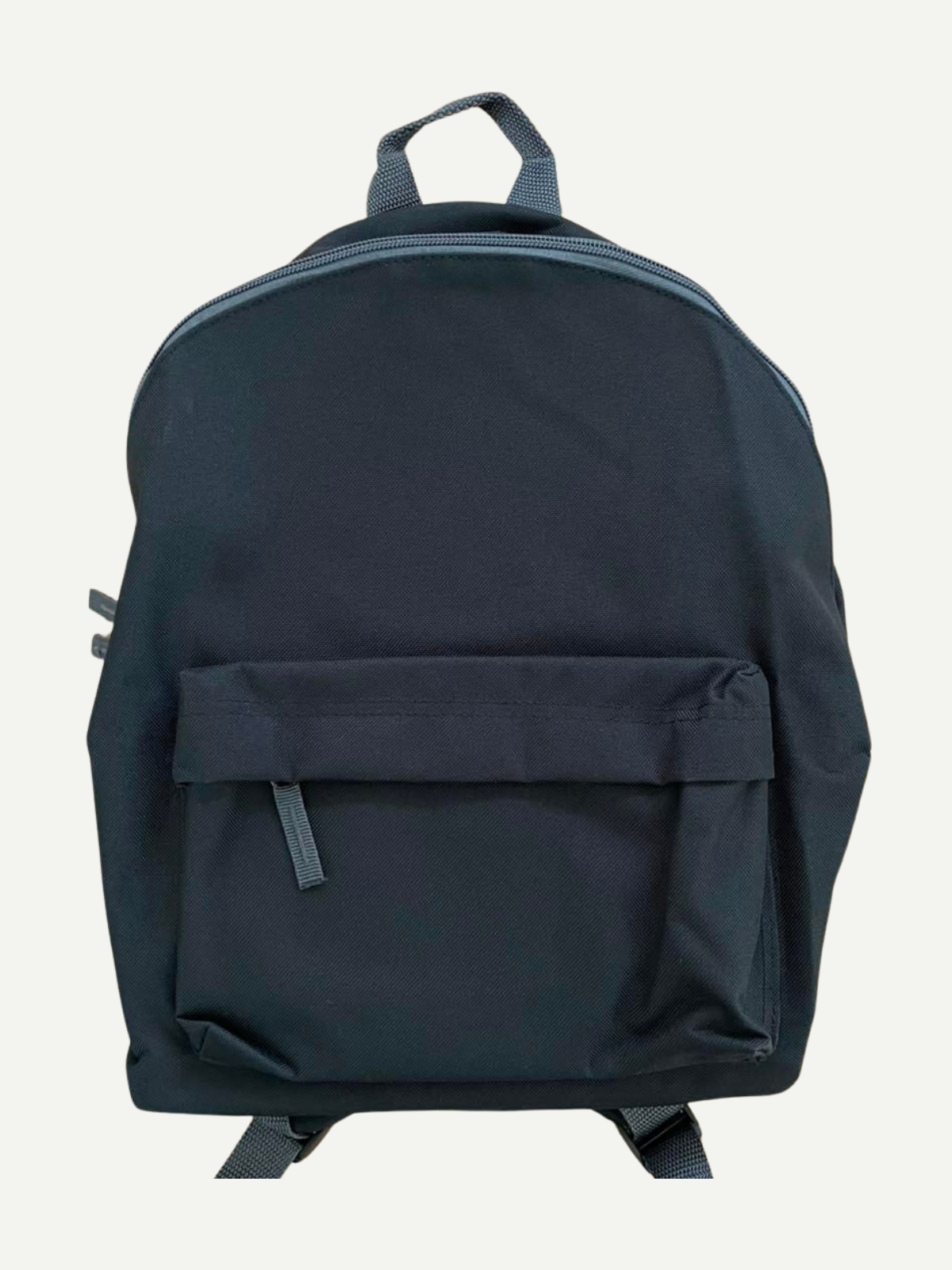 Plain navy children’s backpack with a front zipped pocket and top carry handle, shown before personalisation.