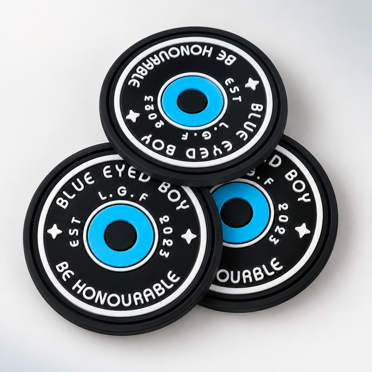 Round custom silicone labels with detailed blue, black and white design