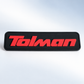 Black custom silicone label with raised red Tolman branding
