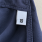 White women’s woven size 18 label sewn into the side seam of a navy garment