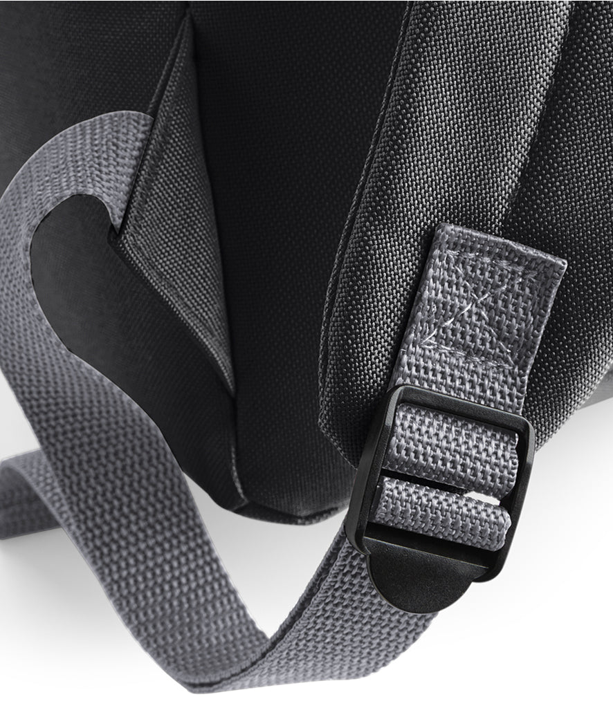 Close-up of the black children’s backpack showing the shoulder strap’s grey webbing and adjustment buckle.