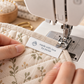 Personalised woven Made with love by Jackie label being sewn onto handmade floral fabric
