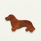 Brown dog-shaped custom leather label with embossed detail on a white background