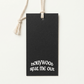 Black custom recycled pulp swing tag with white printed logo and natural cotton cord