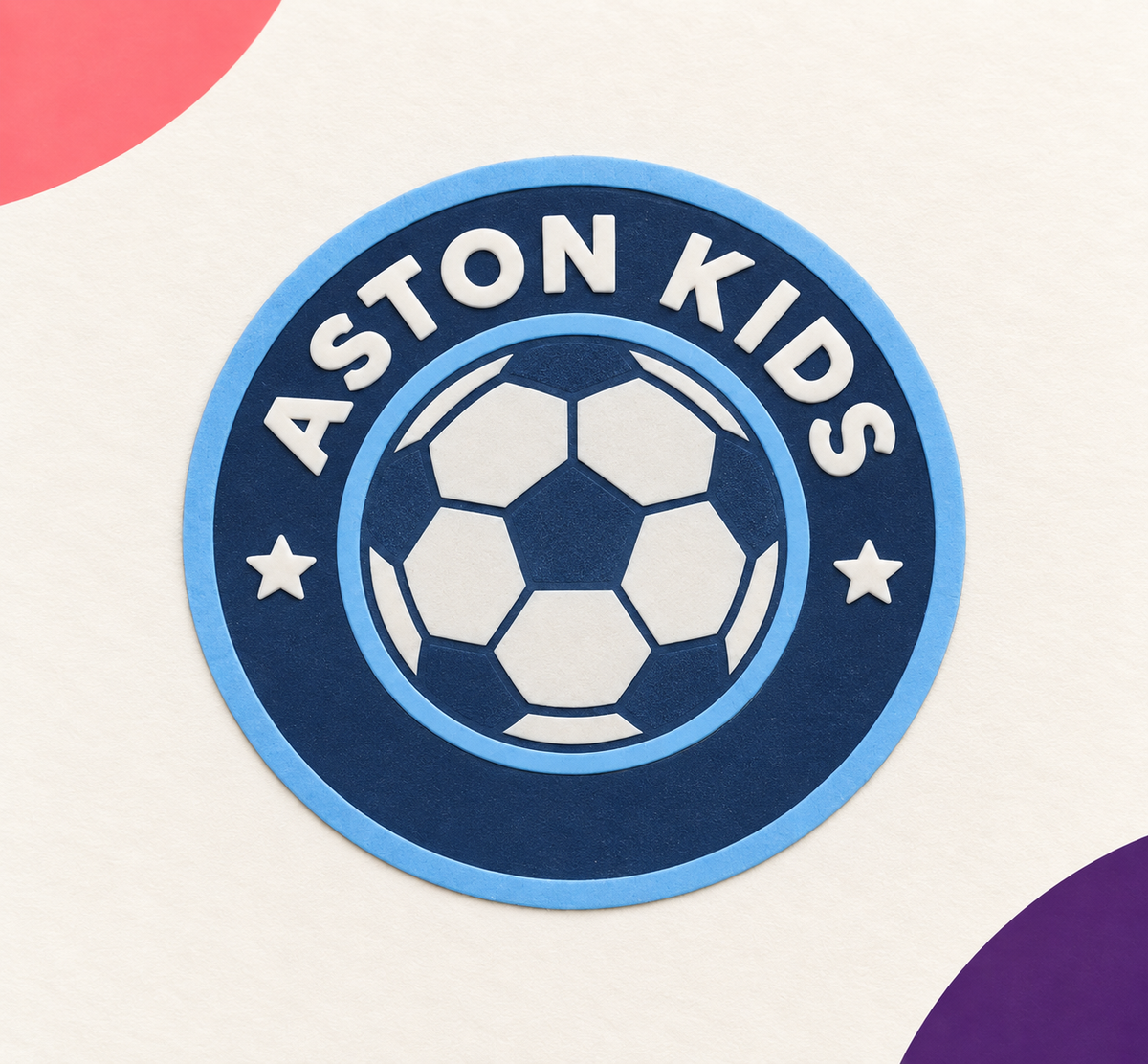 Thin round Aston Kids raised silicone football heat transfer badge in light and dark blue