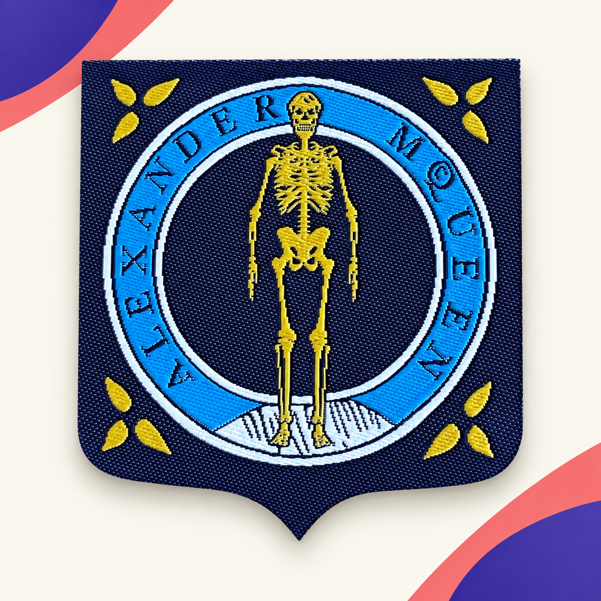 Custom-shaped Alexander McQueen woven badge with blue and gold skeleton design