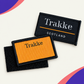 Orange and black custom Trakke woven badges with hook-and-loop backing