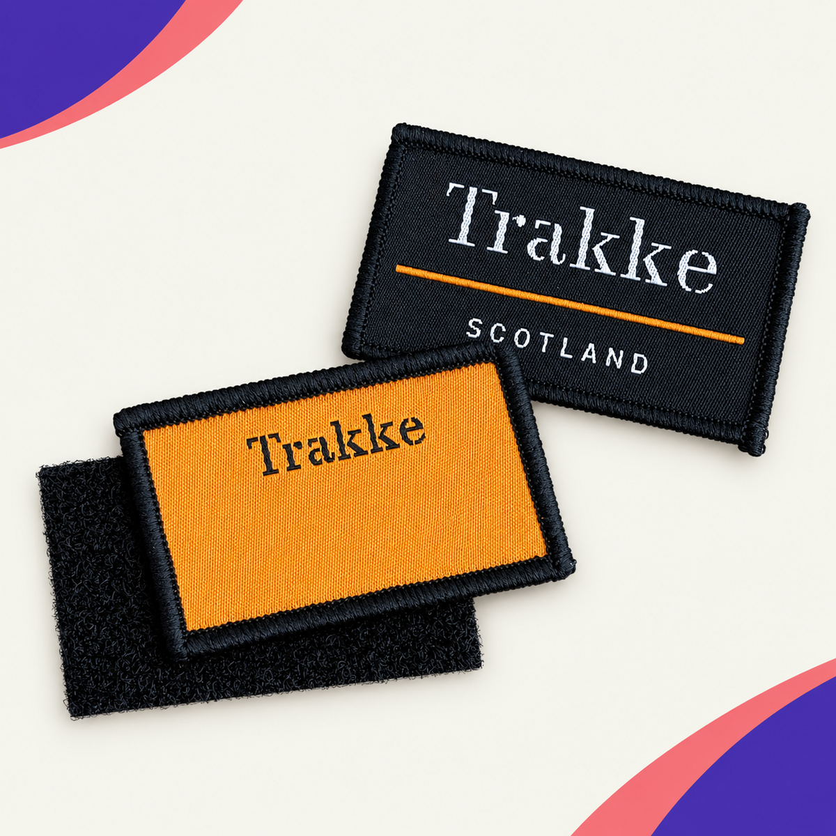 Orange and black custom Trakke woven badges with hook-and-loop backing