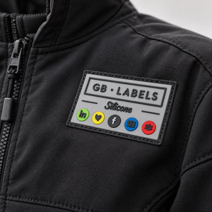 Custom silicone clothing label sewn onto black workwear jacket