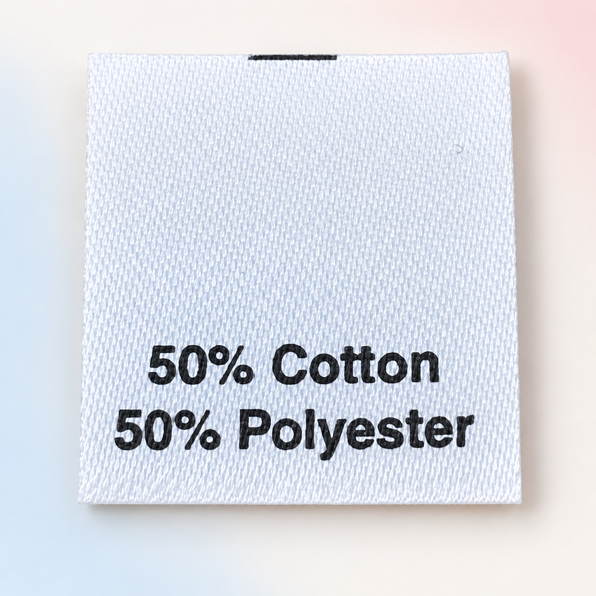White printed satin care label showing 50% cotton and 50% polyester composition